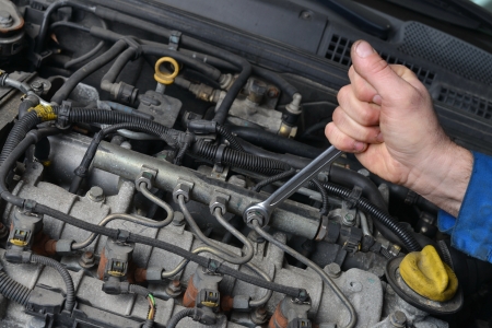 24976367 - auto mechanic is working on engine in car repair shop
